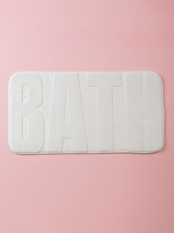 White bathroom mat with lettering