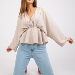 Raquel's light beige triangular neckline blouse