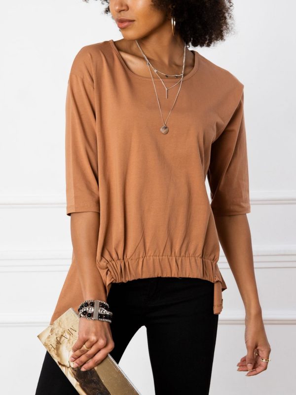 Lily's light brown blouse