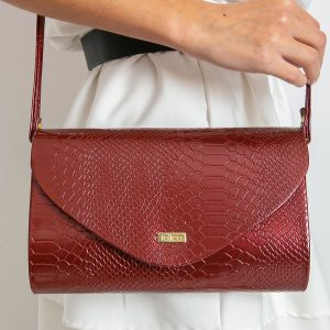 Burgundy clutch bag with snake skin motif