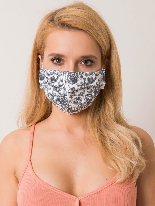 White and black protective mask in roses