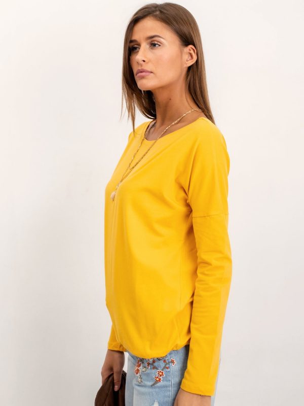 Carla's dark yellow blouse