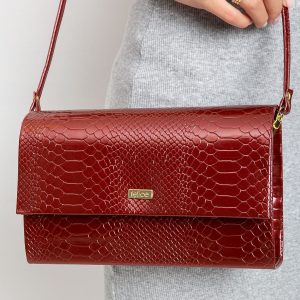 Burgundy patent clutch bag with snake skin motif