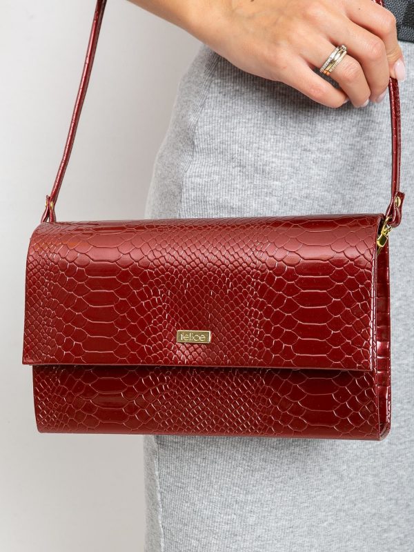 Burgundy patent clutch bag with snake skin motif