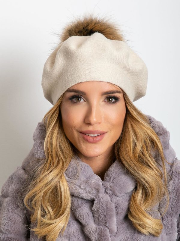 Light beige knitted beret with pompom