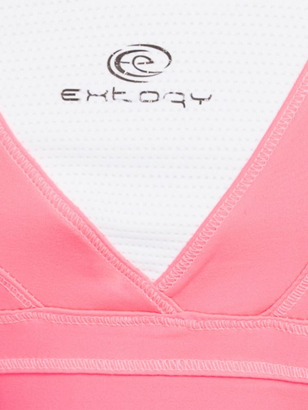 Fluoride pink sports top with crisscrossed shoulder straps on the back