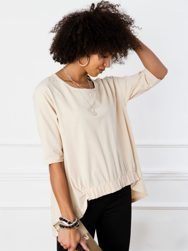 Lily's light beige blouse