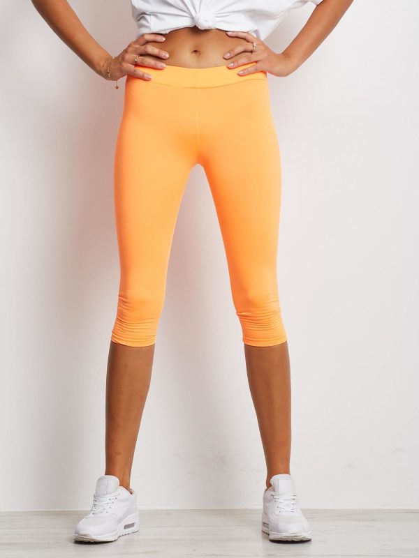 Wholesale Short slightly insulated fitness leggings fluo orange